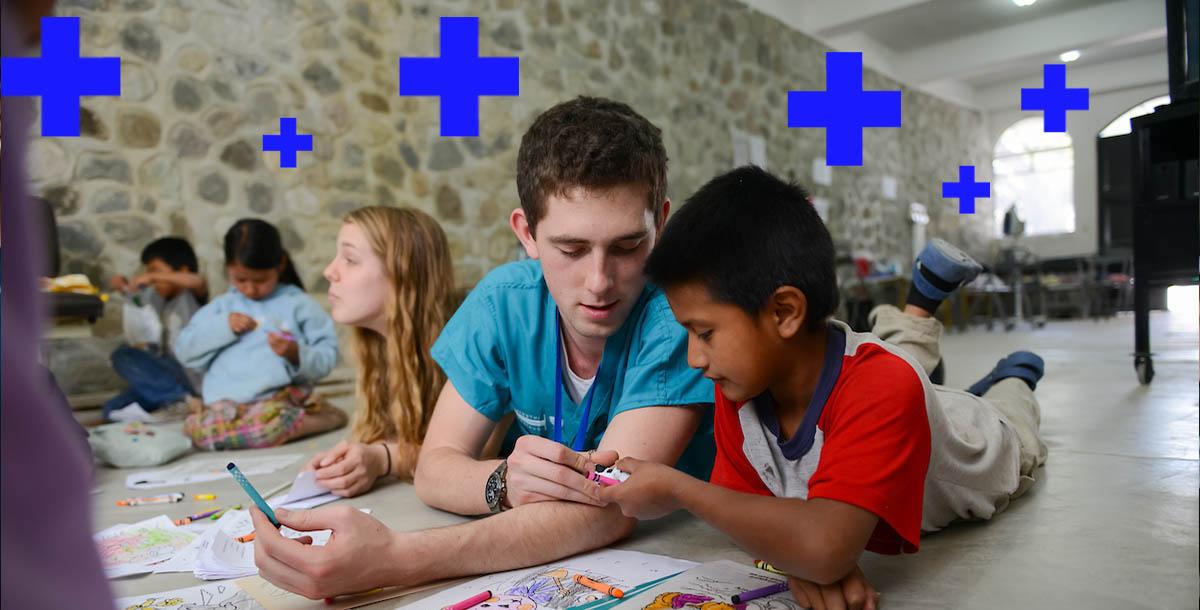 a student coloring with a child 